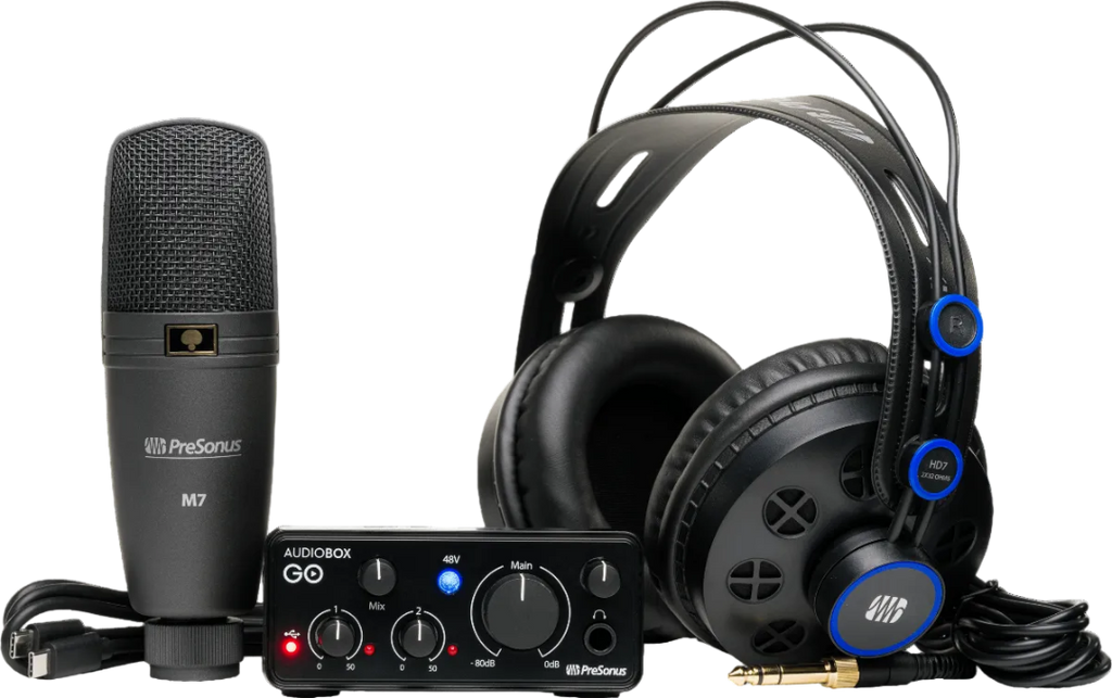 Audio equipment set with microphone, audio interface, and headphones on a white background