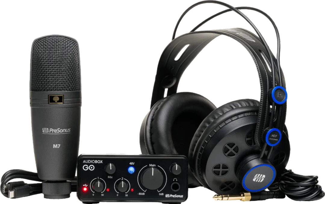 Audio equipment set with microphone, audio interface, and headphones on a white background