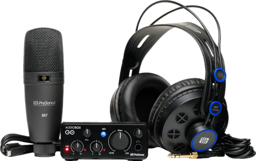 Audio equipment set with microphone, audio interface, and headphones on a white background