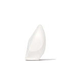 White wireless speaker, angled side view with smooth body on flat base