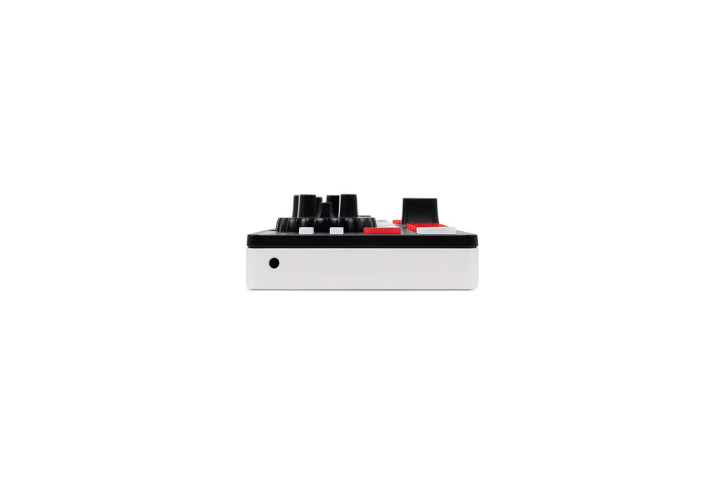 DJ mixer controller end view with multiple black knobs and small red controls