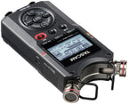 Portable recorder top view with LCD screen, control buttons, and dual mic capsules, dark gray.